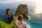 Woman standing on the cliff and enjoying sunset