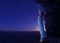 Woman standing on cliff\'s edge of another planet.