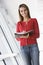 Woman standing in corridor with personal organizer