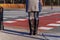 Woman standing on crossroad and waiting to cross