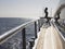 Woman Standing on Deck of Boat