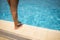 Woman standing on edge of the swimming pool.