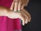 Woman is standing with the finger to rub the gel alcoholic 70 percent mixture with gelatin on the back of the hand to prevent germ