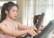 Woman standing on fitness treadmill with friend