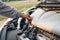 Woman standing in front of a broken car. Car problems. I can`t find where the problem is. What could the problem be.. Broken car