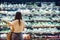 a woman standing in front of a display of food in a grocery store, organic lifestyle and vegan concept