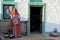 Woman standing in front of house at Jaisalmer, Rajasthan desert