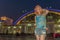 A woman standing in front of the  Hua Lamphong train station in Bangkok