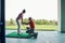 Woman standing on the golf hitting mat