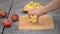 Woman is standing in her kitchen, cutting apples.