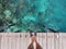 Woman standing on the jetty with beautiful clear water from the surface in Mabul Island, Semporna. Tawau, Sabah. Malaysia.