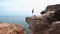 Woman standing and meditating on a cliff over the ocean. Yoga on the cliff.