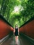 A woman standing in the middle of red wall