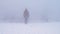 Woman standing on the misty river bank