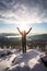 A woman standing on a mountaintop, arms outstretched and face turned towards the sun