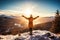 A woman standing on a mountaintop, arms outstretched and face turned towards the sun