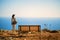 Woman standing near edge of cliff