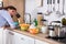 Woman Standing Near Kitchen Sink Looking At Utensils