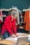 Woman standing near table folding clothes