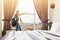 Woman standing near window in hotel room