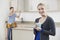 Woman Standing In New Luxury Fitted Kitchen