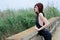 Woman is standing on a old cement bridge