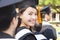 Woman standing out from a graduation group smiling