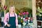 Woman standing outside florist