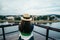 Woman standing on the pier in the city and looking on the river