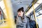 Woman standing in public transportation