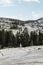 Woman standing on the rocks contemplating the view of the forest and mountains in nature. Summer weather. Vacations