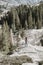 Woman standing on the rocks contemplating the view of the forest and mountains in nature. Summer weather. Vacations