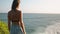 Woman standing on rocky cliff edge Banawa beach