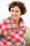 Woman Standing In Sand Dunes Wrapped In Blanket