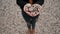 Woman standing on shore of lake holding stones in form of heart