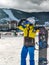 woman standing at ski resort hill with snowboard