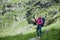 Woman standing on stone at foot of Fagaras Mountains