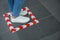 Woman standing on taped floor marking for social distance, closeup. Coronavirus pandemic