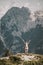 Woman standing at the top of the hill in mountains looking at wonderful scenery. Triglav, the highest slovenian mountain. Trgilav