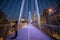 Woman standing on a white bridge above the River Thames during nighttime