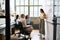 Woman standing at whiteboard in a meeting with female team