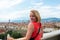 Woman stands against the backdrop of the panorama of Florence, Italy.