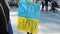 Woman stands with banner Stop Putin. Peaceful rally against Russia invasion of Ukraine. Stop wat. Russia attacks Ukraine. Protest