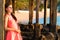 A woman stands on the beach in the evening. The girl at sunset. Attractive young lady enjoying the last rays of the sun