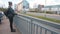 woman stands on bridge city watching movement cars Waiting for meeting date.