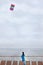 Woman stands on cruise liner deck and flies kite