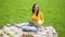 Woman stands on the field with cabbage and broccoli in her hands. Healthy lifestyle concept