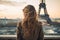 A woman stands in front of the iconic Eiffel Tower in Paris, France, enjoying the beautiful view, Young woman\\\'s rear view