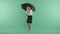 A woman stands holding an umbrella