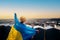 A woman stands with the national Ukrainian flag and waving it praying for peace at sunset in Lviv..A symbol of the Ukrainian